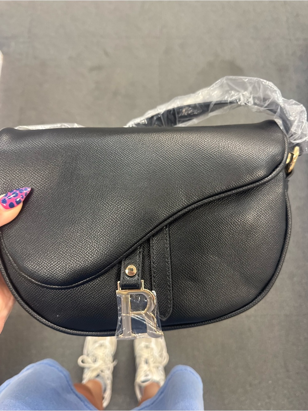 Black Saddle Crossbody Bag with Gold 'R' Charm